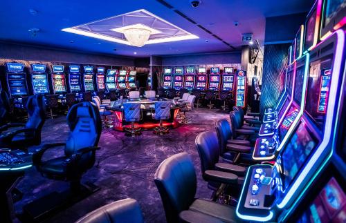 a casino with a bunch of slot machines at HOTEL EUROPA in Komárno