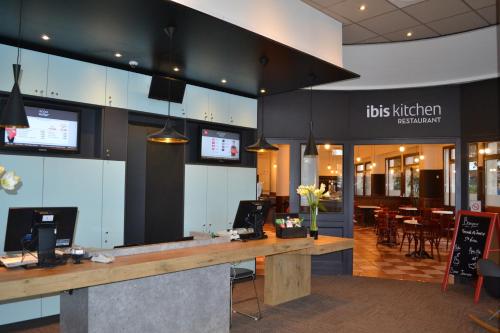 a restaurant with a reception desk in a building at ibis Angers Centre Chateau in Angers