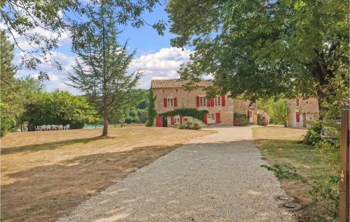 a driveway leading to a large brick house at Stunning Home In St Maixent De Beugné in Saint-Maixent-de-Beugné