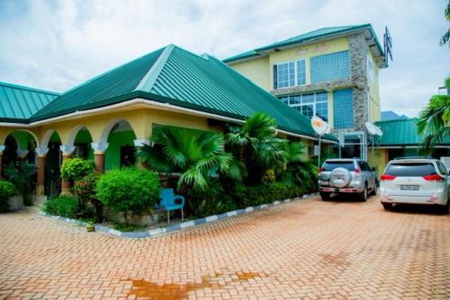 a building with a car parked in front of it at Best Lodge in Tamale