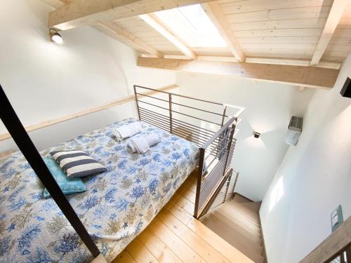 ein kleines Schlafzimmer mit einem Bett im Dachgeschoss in der Unterkunft New Agriloft 3 Agave - Giardino, WI-Fi, clima, a 50 mt dal mare in Bordighera