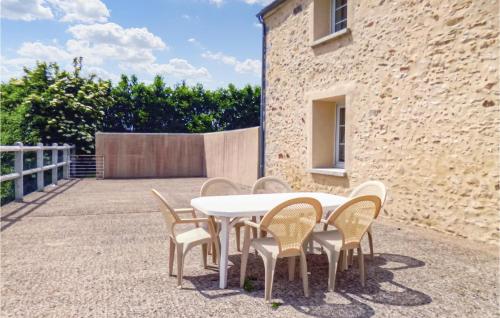 a white table and chairs in front of a building at Nice Home In Vaudoy-En-Brie With Wifi in Vaudoy-en-Brie