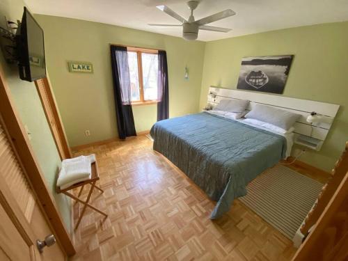 a bedroom with a bed and a ceiling fan at Little Whit on Chautauqua Lake in Mayville