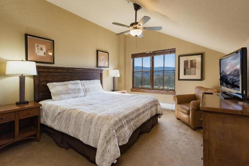 a bedroom with a bed and a flat screen tv at Purgatory Lodge Unit 505 in Durango Mountain Resort