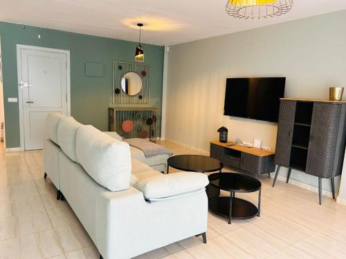 a living room with a couch and a tv at La Maison Amarilla Golf in San Miguel de Abona