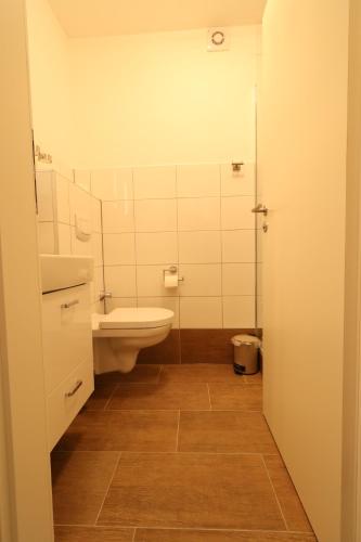 a bathroom with a toilet and a sink at Schiller Pension in Bielefeld