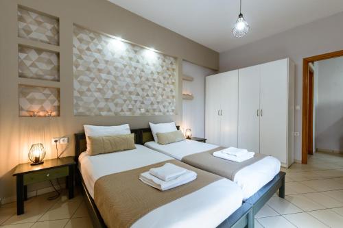 a bedroom with two beds in a room at Gelina Apartments in Plataniás