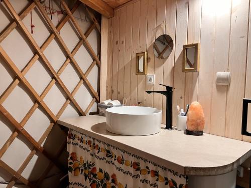 a bathroom with a sink on a counter at Jurta I Sauna z widokiem na Tatry in Knurów