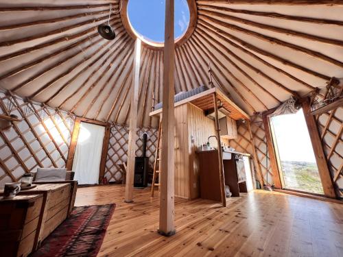 an interior view of a yurt with a round window at Dzikość Serca - Jurta z widokiem na Tatry in Knurów