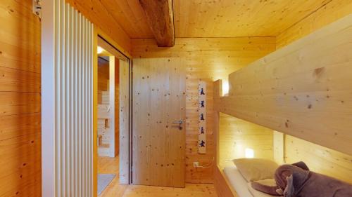 a wooden cabin with a tub in a room at Mountain Cabin Mutten-Graubünden in Mutten