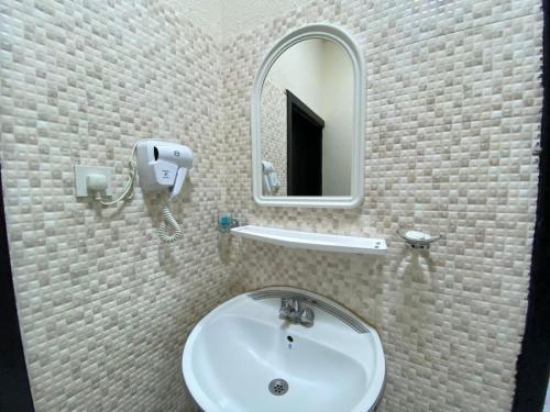a bathroom with a sink and a mirror at Qasr Aldabab Housing Units in Abha