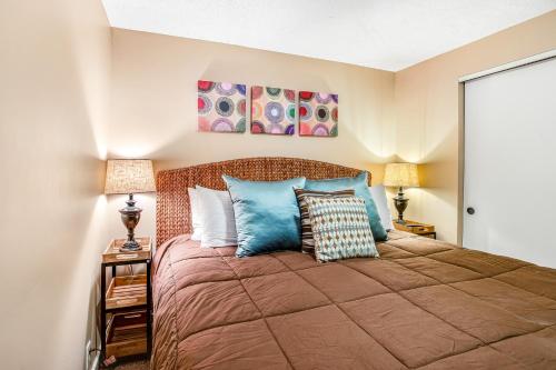 a bedroom with a large bed with blue pillows at Gourmet Cook's Retreat in Cannon Beach