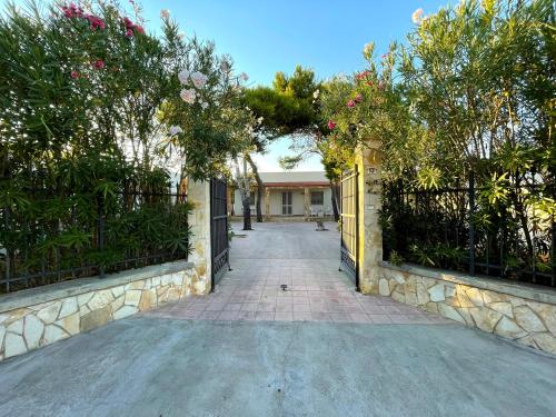 an entrance to a house with a fence and a driveway at Villa Luce in Torre rinalda