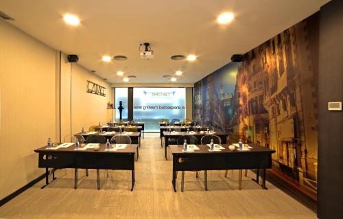 a restaurant with tables and chairs in a room at Hotel Indigo Madrid - Gran Vía by IHG in Madrid