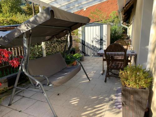 a bench under an umbrella on a patio at The OldMillhouse in Mojstrana