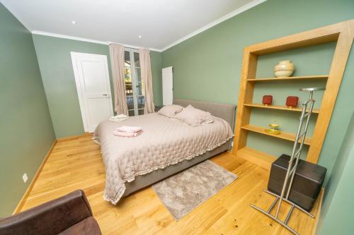 a small bedroom with a bed and a book shelf at Luxury 3 bedroom apartment - old town of Sion in Sion