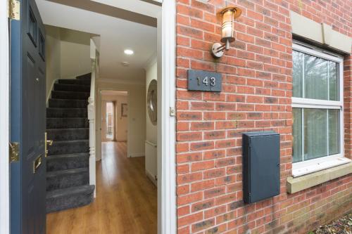 a brick wall with a house number on it at Great Park Townhouse in Preston