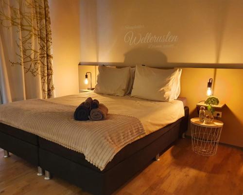a bedroom with a bed with two bags on it at B&B Mooi Montferland in Zeddam