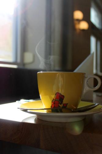 a coffee cup on a plate on a table at Hotel Blie, Bed & Breakfast, Self Check-in in Horn