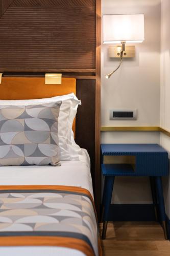 a bedroom with a bed and a blue nightstand at Grand Hotel Torre Fara in Chiavari