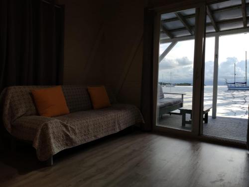 a living room with a couch and a large window at Santuarios del Mar in Bocas del Toro