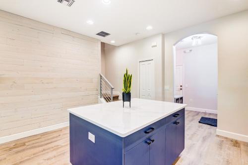 a kitchen with a blue island with a plant in a vase at Sea Flamingo in Cape Canaveral