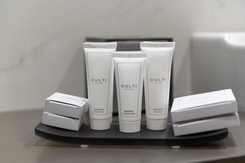 a shelf with four tubes of cream on it at Grand Hotel Torre Fara in Chiavari