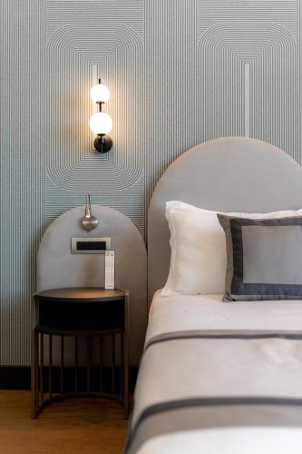 a bedroom with a bed and a side table at Grand Hotel Torre Fara in Chiavari