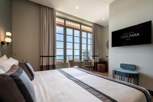 a hotel room with a bed and a tv at Grand Hotel Torre Fara in Chiavari
