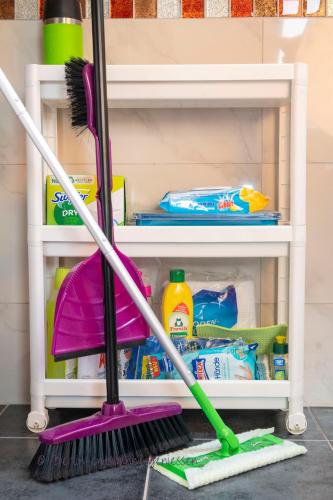 a broom and cleaning supplies in a drawer at Berlin entspannt geniessen in Berlin