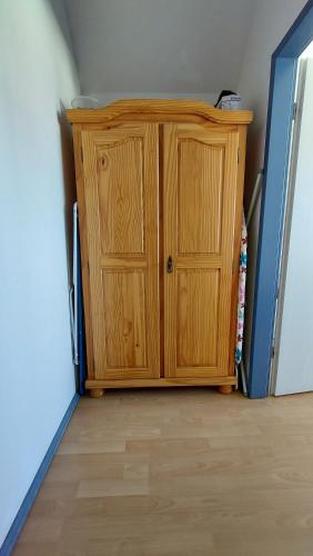a wooden cabinet in the corner of a room at Ferienwohnung Weitblick Breege in Breege