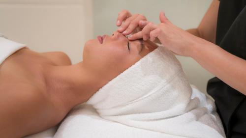 a woman getting a massage in a towel at Four Seasons Hotel Megeve in Megève