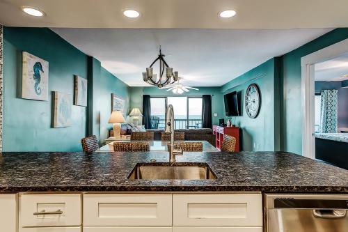 a kitchen with a sink and a living room at x Sea Marsh II 503 in Myrtle Beach