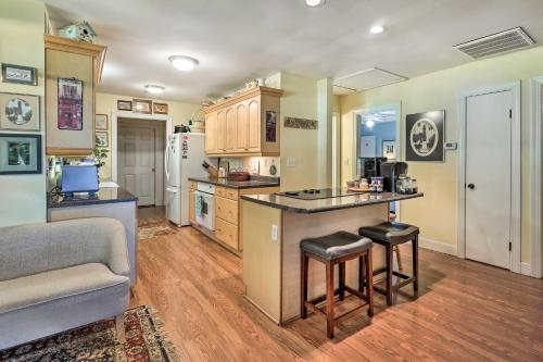 a kitchen with a counter and a couch and a table at Rustic Beaufort Home with Stunning Marsh Views! in Beaufort