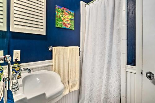 a bathroom with a white sink and a white shower curtain at Rustic Beaufort Home with Stunning Marsh Views! in Beaufort