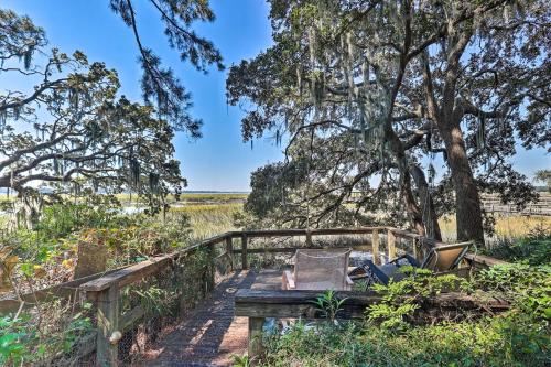 a wooden bridge over a field with a tree at Rustic Beaufort Home with Stunning Marsh Views! in Beaufort