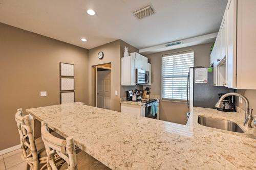 a kitchen with a large granite counter top in a room at Marco Island Condo with Shared Pool and Hot Tub! in Marco Island