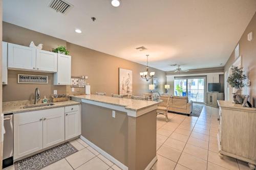 a kitchen with white cabinets and a living room at Marco Island Condo with Shared Pool and Hot Tub! in Marco Island