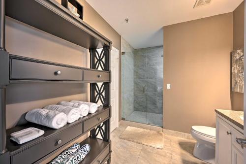 a bathroom with a shower and a toilet and towels at Marco Island Condo with Shared Pool and Hot Tub! in Marco Island