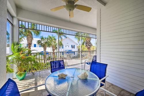 a patio with a table and chairs and a ceiling fan at Marco Island Condo with Shared Pool and Hot Tub! in Marco Island