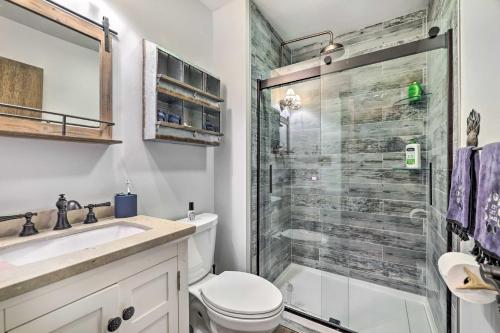een badkamer met een douche, een toilet en een wastafel bij Secluded Cresco Cabin with Deck and Forest Views! in Cresco