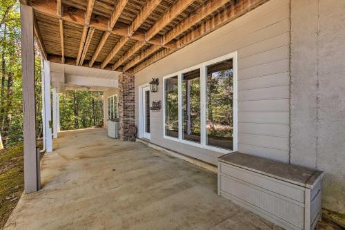 an empty porch of a house with a bench on it at Lakefront Lineville Retreat with Private Dock! in Lineville