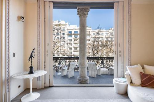 a room with a large window with a view of a city at El Palauet Royal Suites in Barcelona