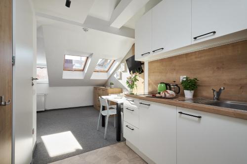 a kitchen with white cabinets and a sink at Villa Alpina - 5 minut do szlaków i wyciągów in Szklarska Poręba