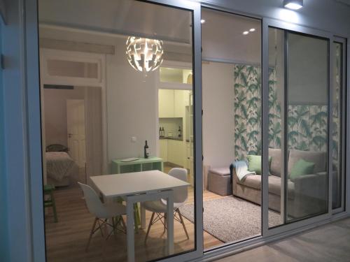 a living room with a table and a couch at Apartamento Roma in Lisbon