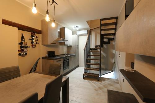 a kitchen with a spiral staircase in a room at PETITE MAISON in Lanciano