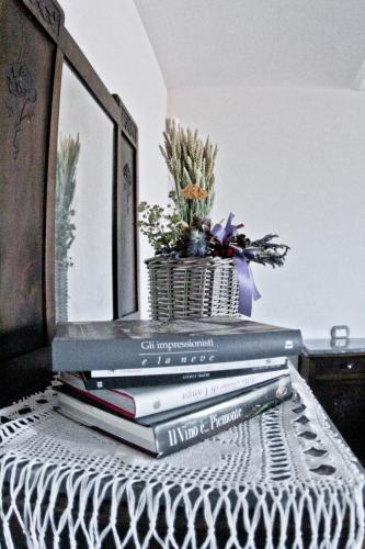 a stack of books sitting on top of a table at Agriturismo Rivella in Barbaresco
