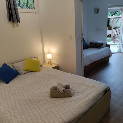 une chambre avec un lit avec un animal en peluche dessus dans l'établissement Idéal pied à terre proche Cannes & Sophia, parking, à Mougins