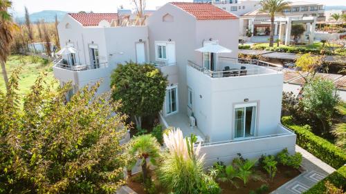 an aerial view of a white house with trees at Gelina Apartments in Plataniás
