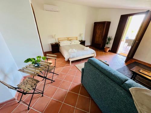 a living room with a couch and a bed at Giove Umbria historic stone farmhouse with pool and detached apartments for a total of 12 guests in Giove